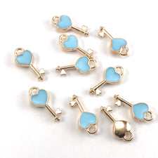 blue and gold jewelry charms shaped like keys