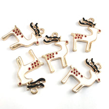 five white red and black reindeer shaped jewelry charms