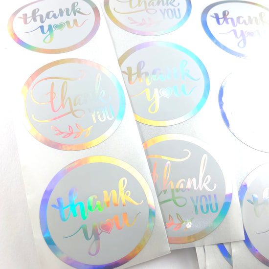 round silvery stickers with thank you on them