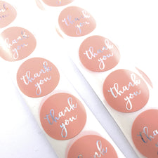 round pink colour stickers with Thank You on them