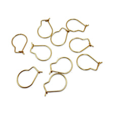 small gold metal wire loops with a hook-like shape, arranged on a plain white background.