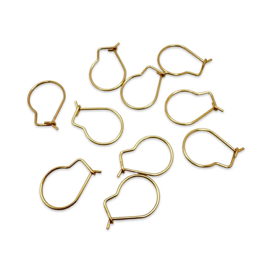 small gold metal wire loops with a hook-like shape, arranged on a plain white background.