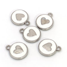 white and silver enamel charms with a heart on them
