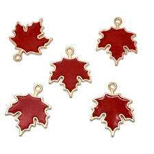 Five red maple leaf charms with gold metal borders and hanging loops, arranged on a plain white background.