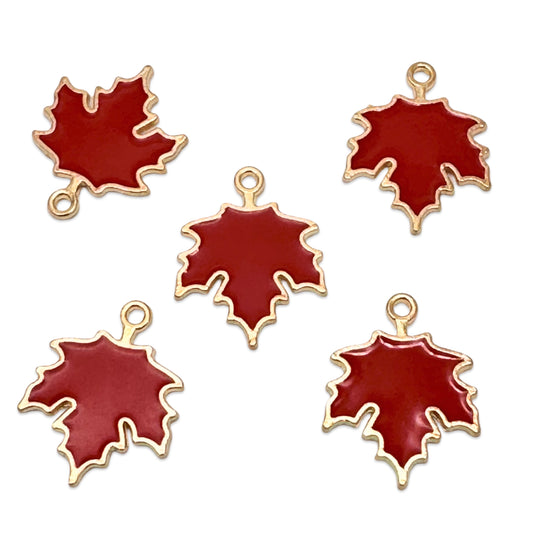 Five red maple leaf charms with gold metal borders and hanging loops, arranged on a plain white background.