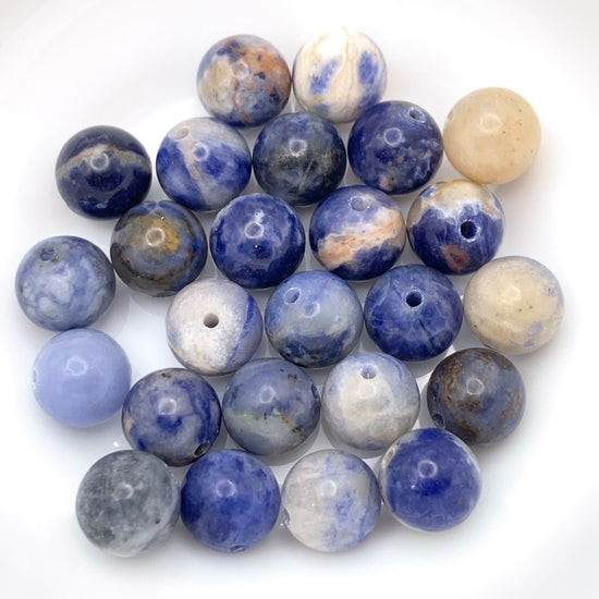 round jewelry beads that are blue, tan, orange in colour