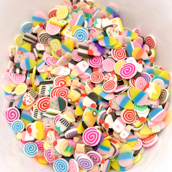 polymer clay pieces that look like assorted treats like ice cream cakes candy