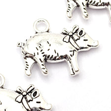 silver colour jewelry charms that look like pigs