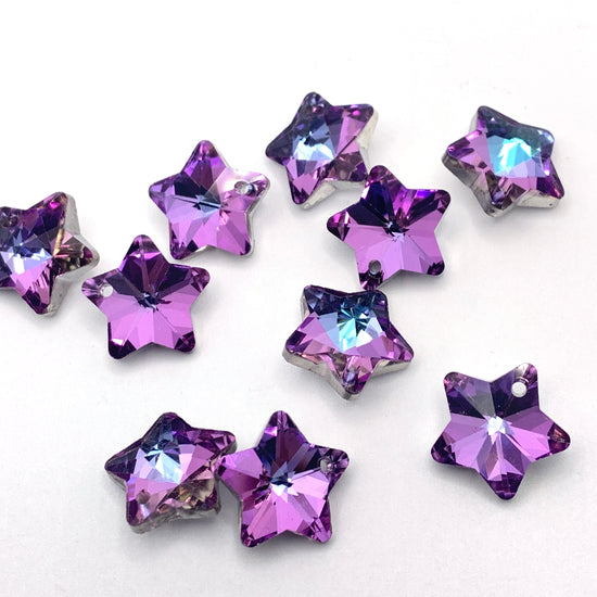 purple glass star shaped charms with some blue accents