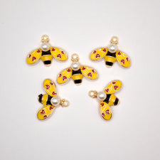 Five enamel yellow bee charms