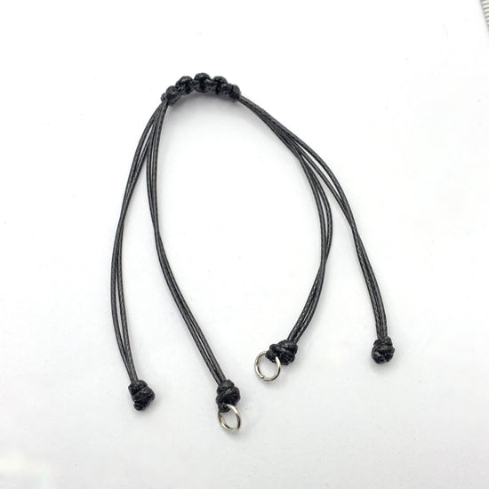 black cord bracelet with silver jump rings