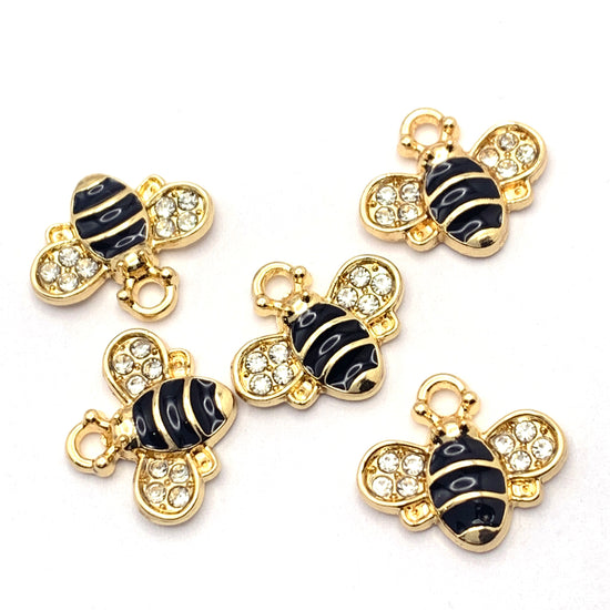 five black and gold bee shaped charms with clear glass rhinestones