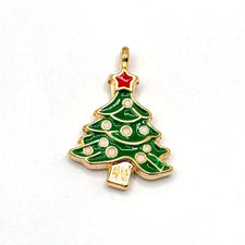 close of of green red white and gold jewelry charms in the shape of a christmas tree