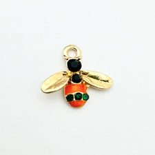 bee shaped jewelry charms that are orange and gold with green rhinestones