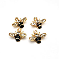 Four black and gold bee shaped jewelry charms