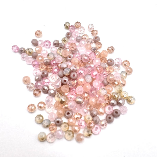 rondelle faceted beads that are a mix of pink toupe, peach colours