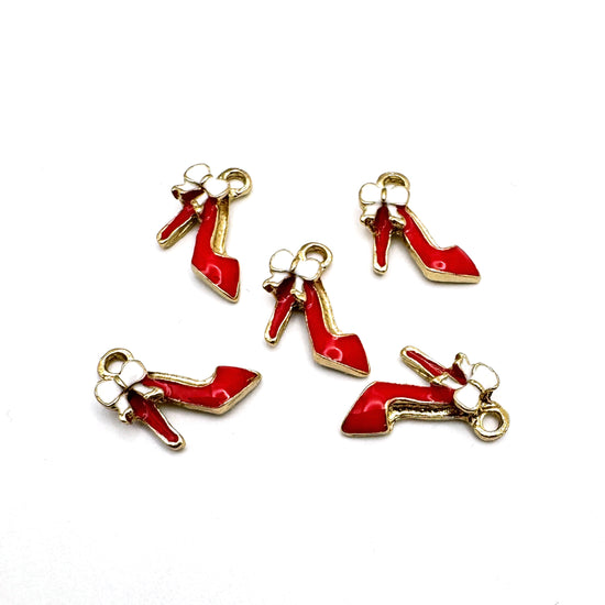 Five red jewelry charms in the shape of high heel shoes