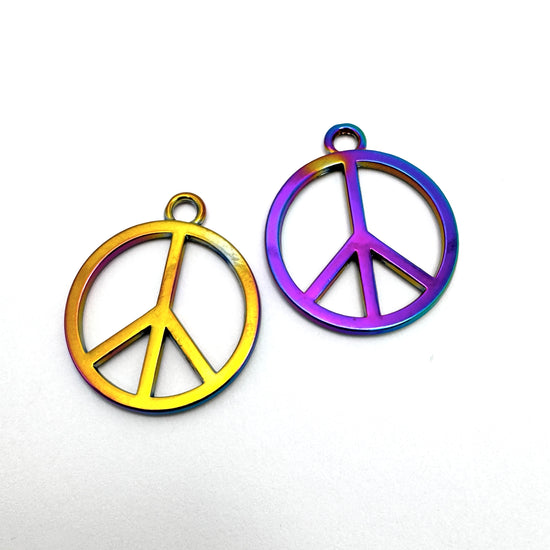 yellow and purple pendants in the shape of a peace symbol