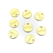 round gold charms with the word love on them