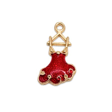 gold and red jewelry charm that looks like a red party dress on a hanger