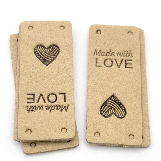 beige rectangle cloth tag that says made with love on it