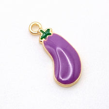 purple and gold jewelry charm that looks like an eggplants