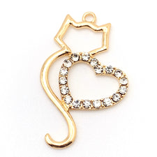 gold colour cat shaped jewerly pendant with clear glass rhinestones in the shape of a heart