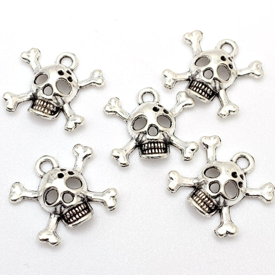 silver jewerly charms that look like skull and crossbones
