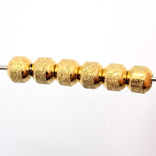 round textured beads that are gold colour