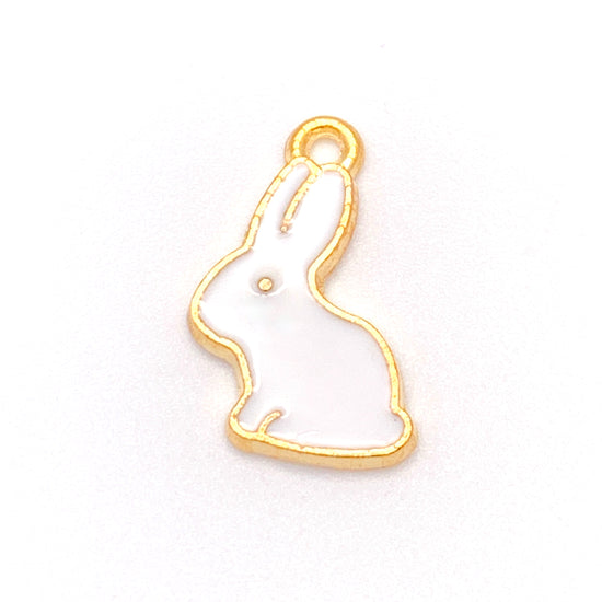 white and gold jewelry charm shaped like a bunny rabbit