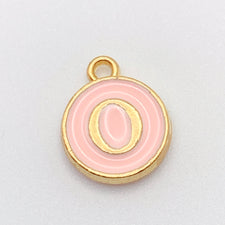 pink and gold round jewerly charm with the letter O on it
