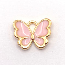pink and gold jewelry charm shaped like a butterfly