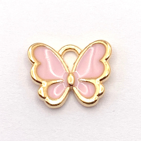 pink and gold jewelry charm shaped like a butterfly