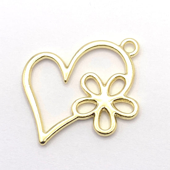 golden jewerly pendant that is a motif of a heart with flower
