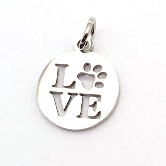 round silver jewerly charm with the word "love" on it, the o being a paw print