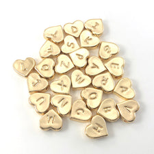 26 heart shaped beads with letters on them
