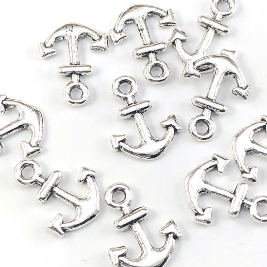 silver colour jewerly charms shaped like anchors