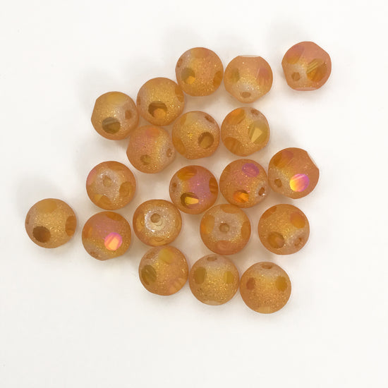 orange glass jewelry beads with golden highlights