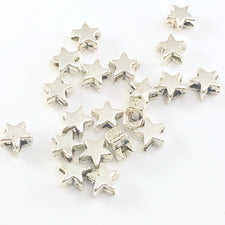 pile of silver jewerely beads shaped like stars