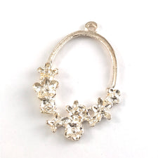 oval shaped rose gold bezel with flower shapes around the bottom