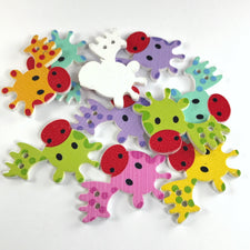 10 wooden colourful buttons shaped like cartoon cows