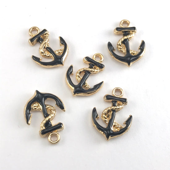 black and gold jewerly charms shaped like anchors