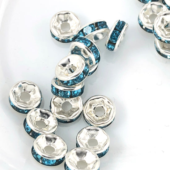 silver rondelle shaped beads with blue rhinestones