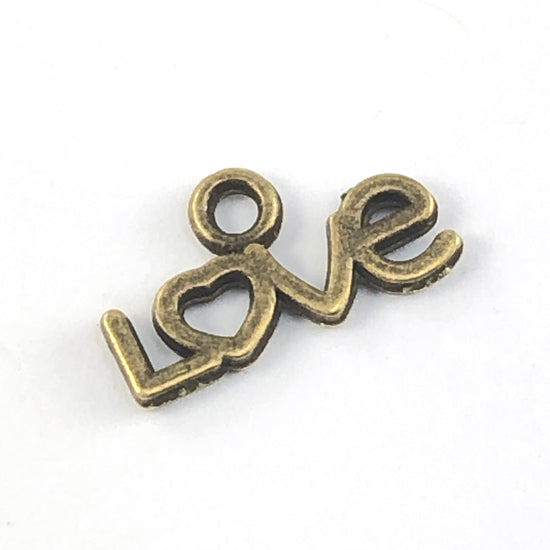 bronze colour charm that in the shape of the word love