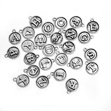 round silver jewelry charms with letters on them