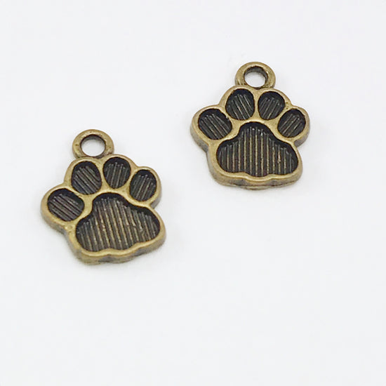 two jewelry charms that look like paw prints