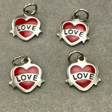 four stainless steel jewelry charms heart shaped with the word love on them