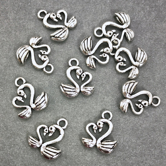 ten antique silver swan shaped jewelry charms