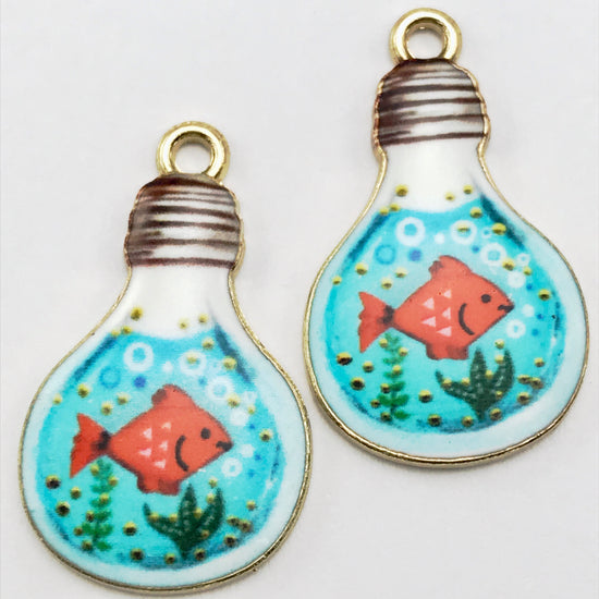 2 jewelry charms shaped like a light bulb with enamel fish painting
