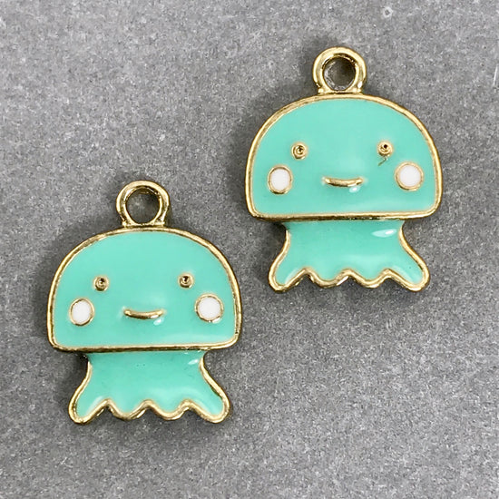 two enamel jewelry charms shaped like jellyfish